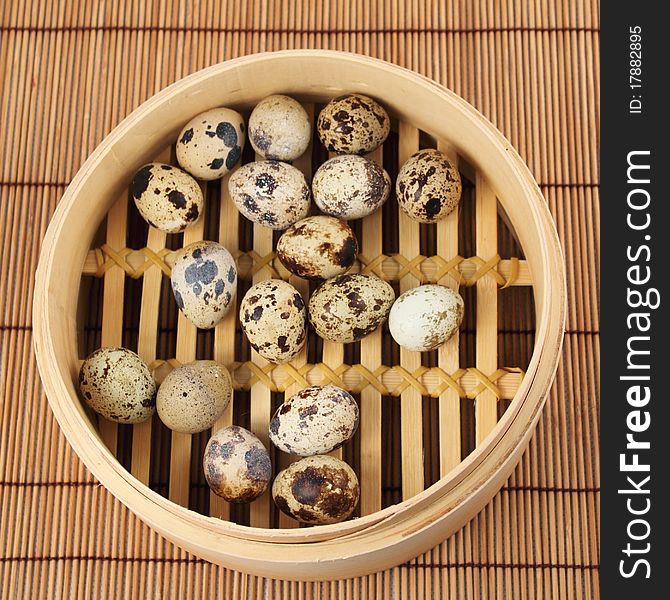 Quail eggs in a bamboo basket