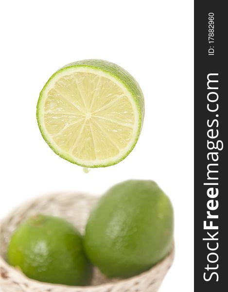 Fresh lime slit in half isolated on white