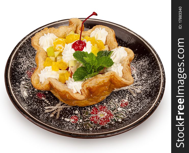 Closeup of fresh baked home made basket cake and maraschino cherry on top isolated on white