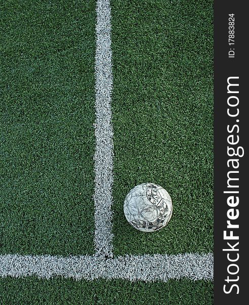 Artificial grass soccer field and old football