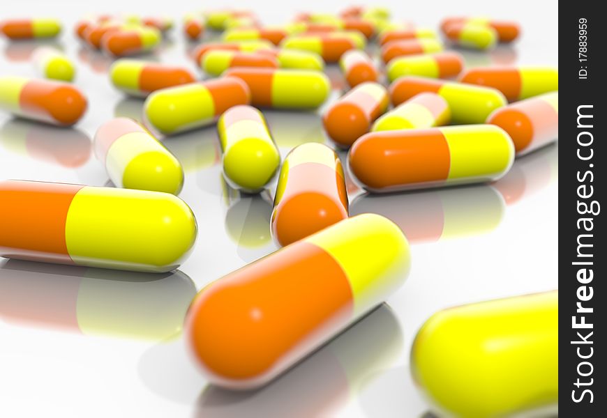 Orange and Yellow pills on a mirroring ground