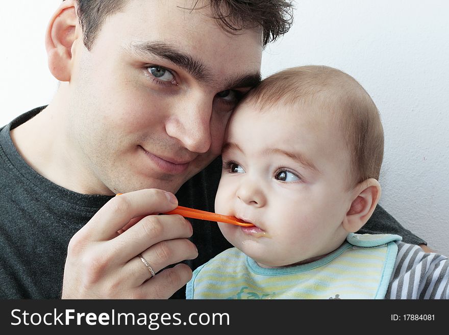 Father giving food to baby