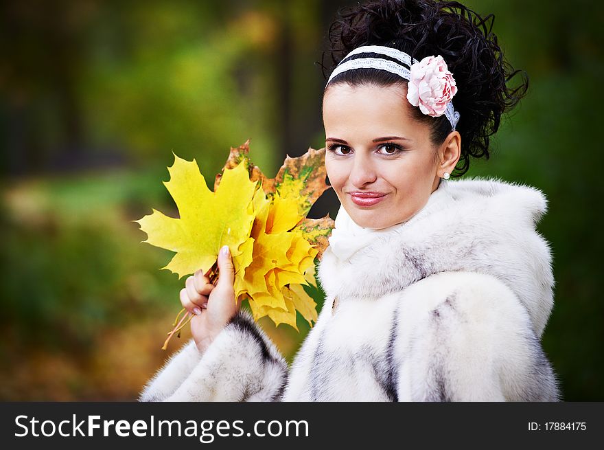 Style happy bride with yellow leaves in autumn park on wedding walk