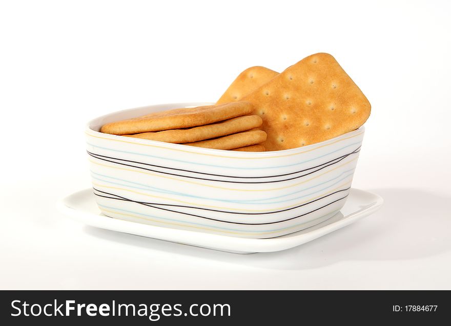 Stack of cookies on a saucer close-up isolated on white background