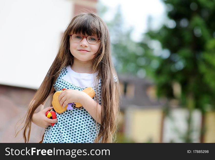 Little girl plays with toy food