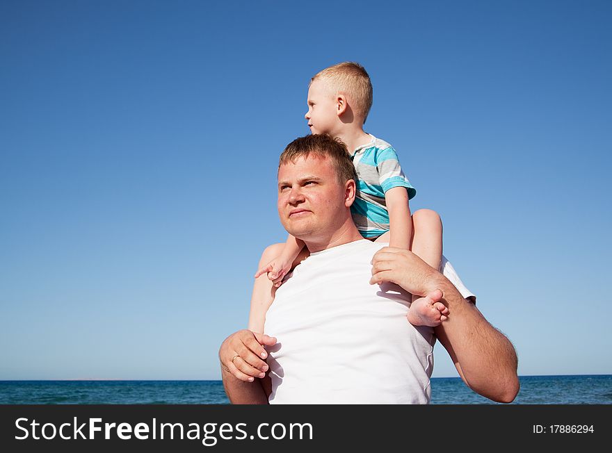 Father with son on shoulders, sunny day, blue sky. Father with son on shoulders, sunny day, blue sky