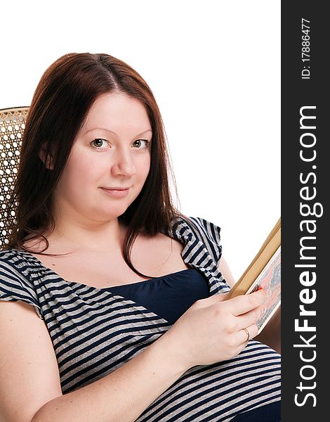 Pregnant woman reading a book in a rocking chair, isolated on white