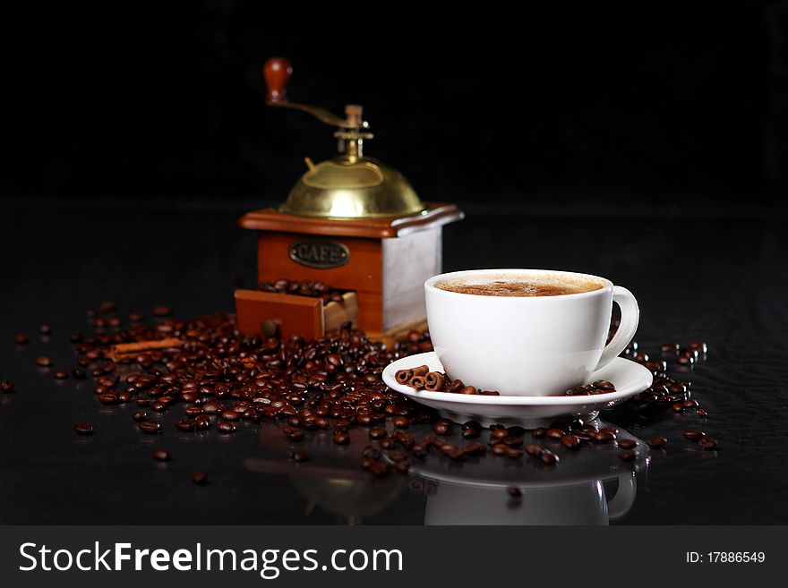 Coffee Mill On The Table With Coffee Beans Around