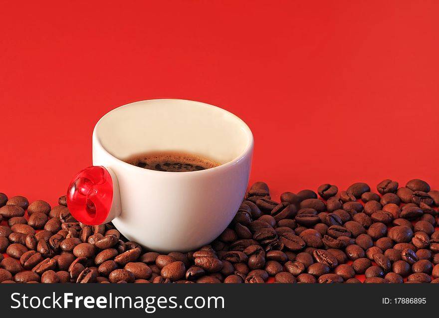 White cup of coffee and coffee beans