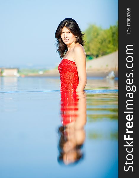 Girl dressed in red dress on a coast. Girl dressed in red dress on a coast