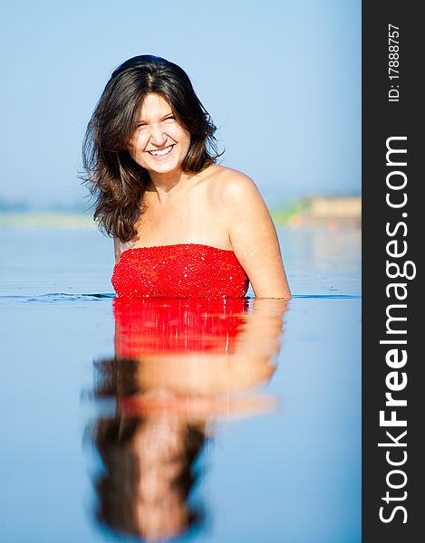 Girl dressed in red dress on a coast. Girl dressed in red dress on a coast