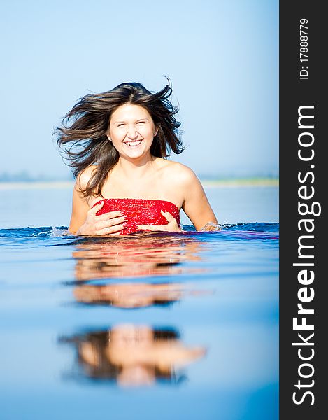 Woman In Red Dress On Coast