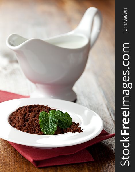 Cocoa powder in a bowl and milk. Cocoa powder in a bowl and milk