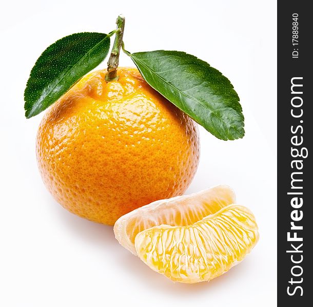 Image of a ripe tangerine with leaves on white background.