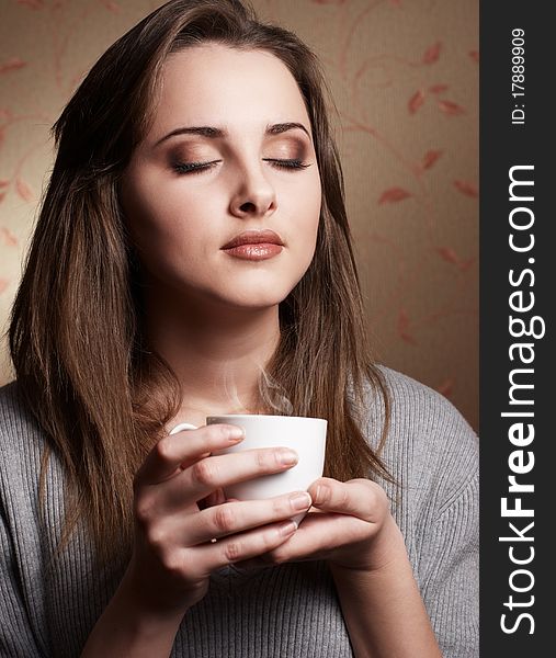 Beautiful young woman with cup of coffee