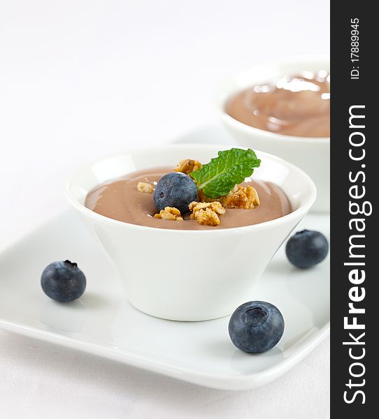Fresh caramel pudding in bowl with bilberries. Fresh caramel pudding in bowl with bilberries