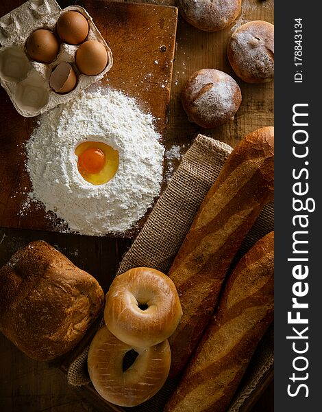 Fresh bread image.
Breads,baguettes,bagels and flour with some eggs.