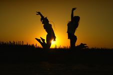 Two Young Women In Silhouette Jumping Stock Photo Two Young Women In Silhouette Jumping Stock Photo