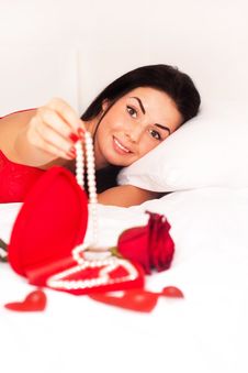 Girl Lying In Bed, Strewn With Hearts And Roses Royalty Free Stock Image
