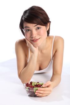 Beautiful Woman Lying On Floor With Bowl Of Fruit Stock Photography