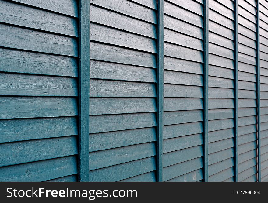 The green boards in lines. A facade or wall of an wood house. The green boards in lines. A facade or wall of an wood house.