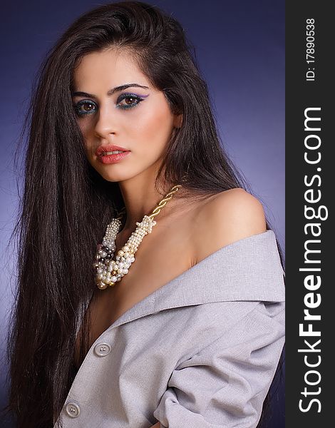 Studio photo of woman whearing a pearl necklace. Studio photo of woman whearing a pearl necklace