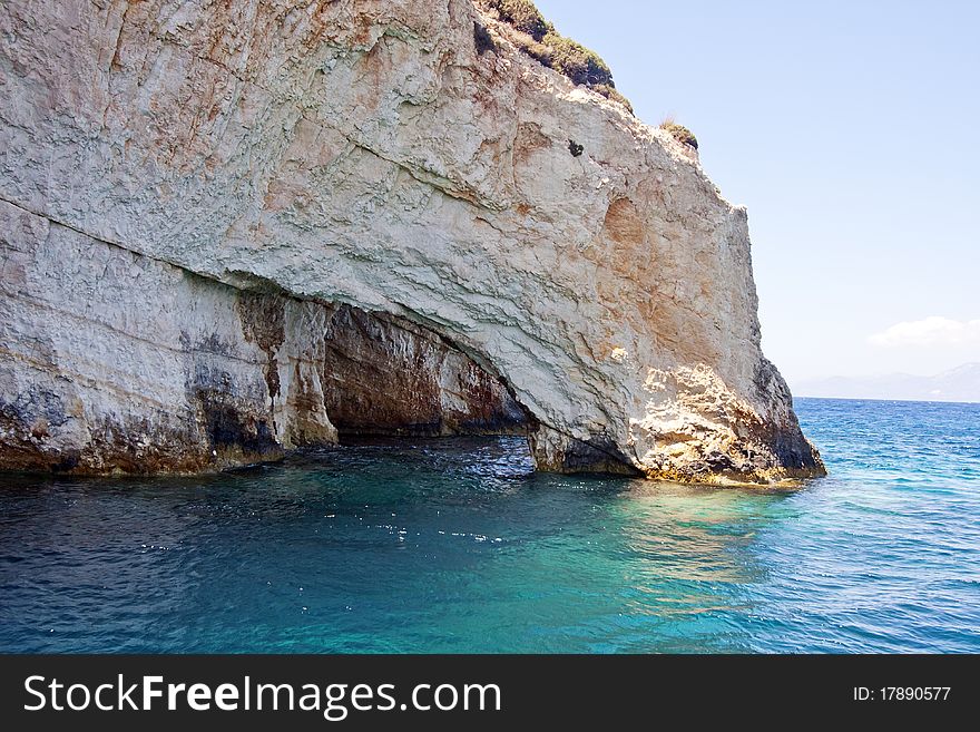 Rocky cliff surrounded by blue ocean