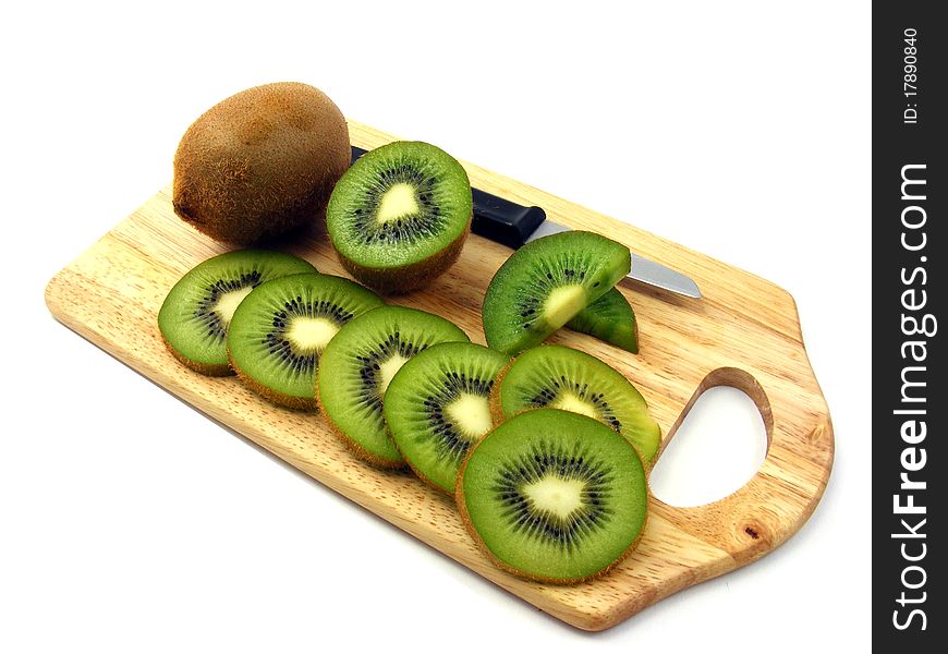 Sliced & whole kiwi fruits on a wooden chopping board. Sliced & whole kiwi fruits on a wooden chopping board