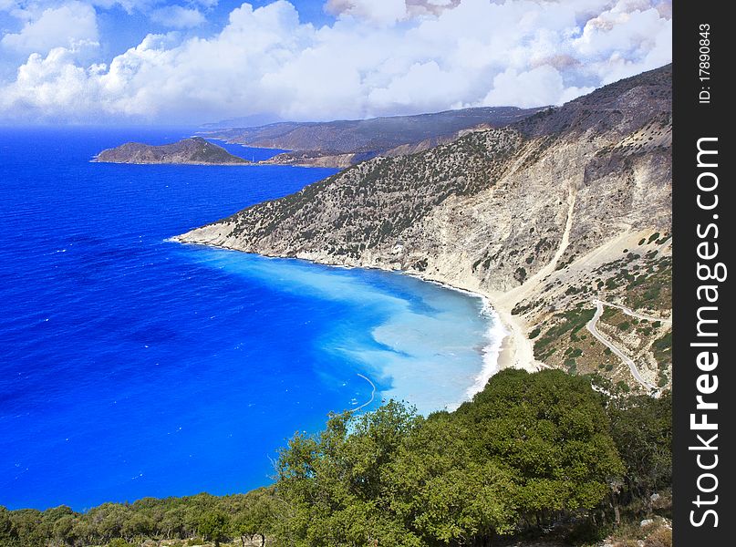 Beautiful beach with blue water and rocky shore