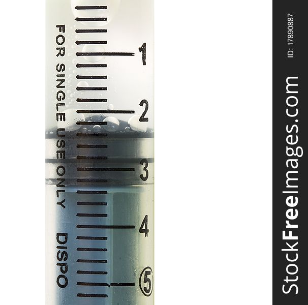 Disposable 5ml syringe with liquid inside close up isolated. Disposable 5ml syringe with liquid inside close up isolated