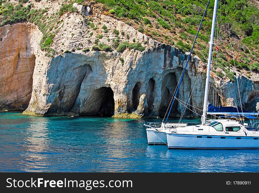 Boat Docked Near Rocky Shore In the Sea