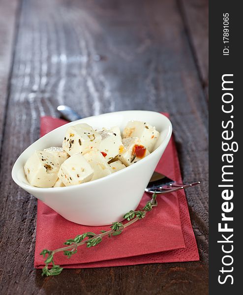 Fresh feta cubes with herbs in a bowl. Fresh feta cubes with herbs in a bowl