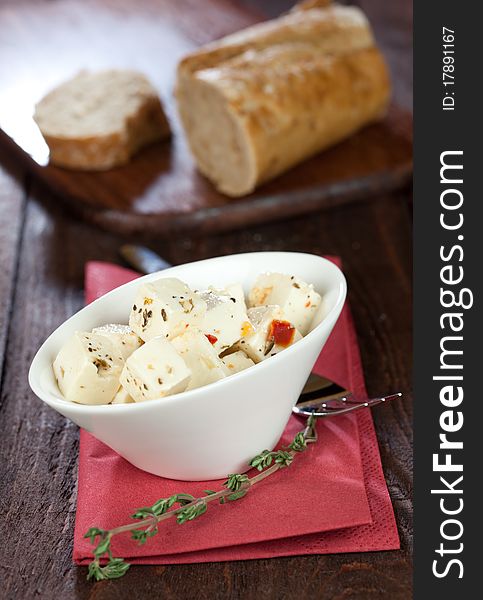 Fresh feta cheese cubes in a bowl with baguette. Fresh feta cheese cubes in a bowl with baguette