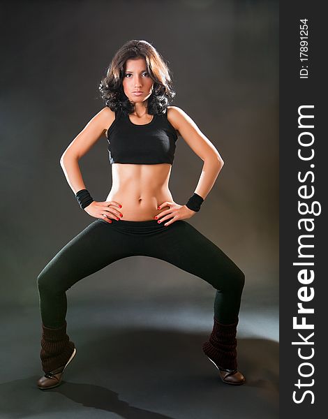 Girl is engaged in fitness on a black background. Girl is engaged in fitness on a black background