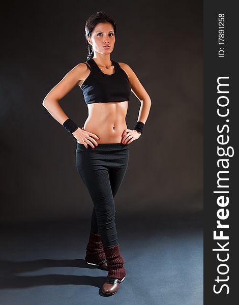 Girl is engaged in fitness on a black background. Girl is engaged in fitness on a black background