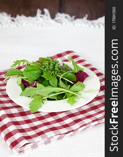 Fresh mixed green salad on plate. Fresh mixed green salad on plate