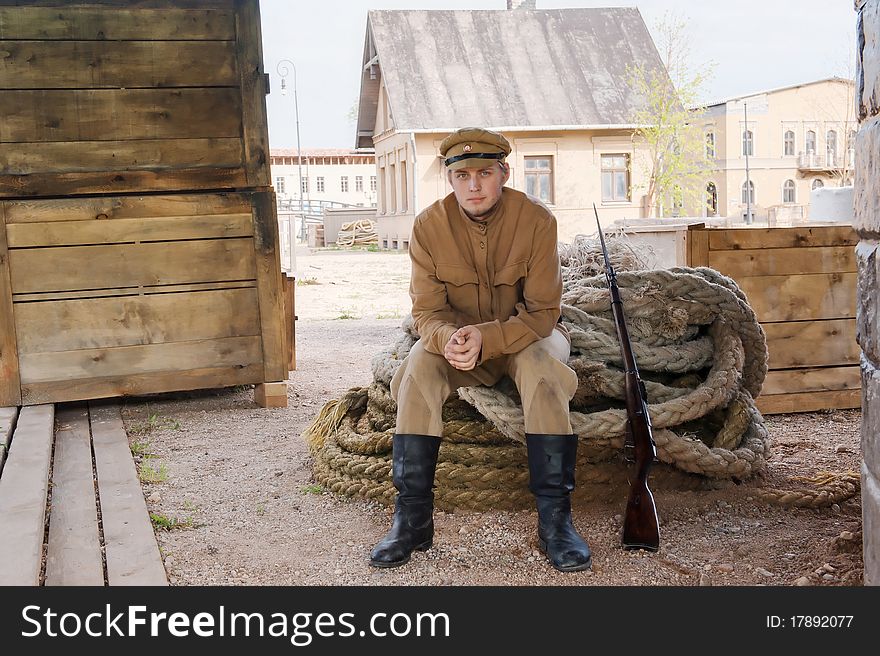 Retro style picture with soldier sitting on rope