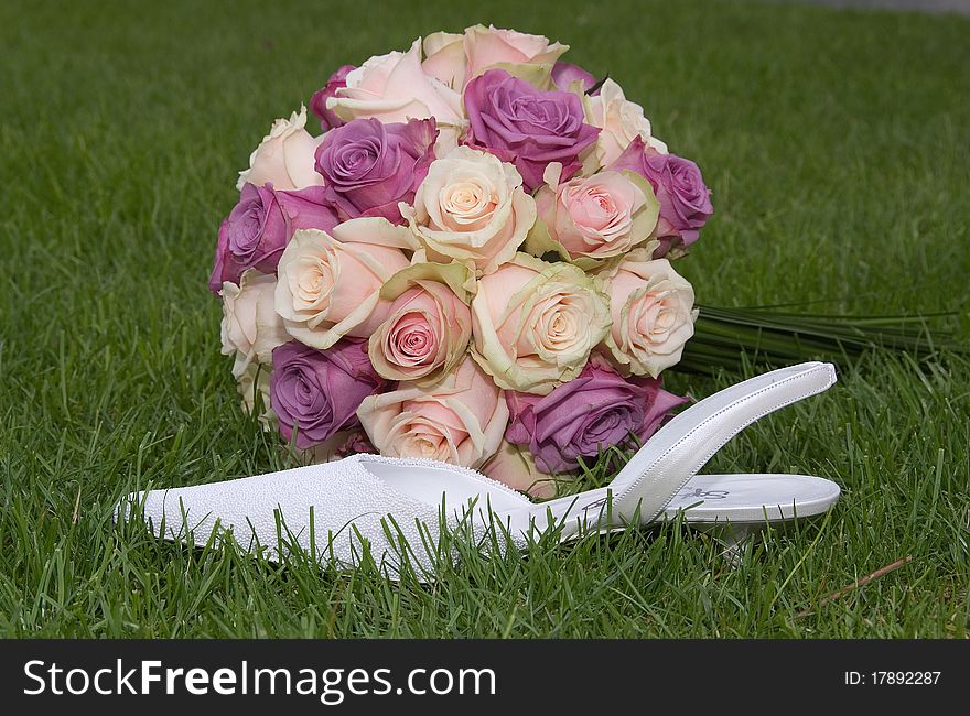 Beautiful bridal bouquet with shoe in thr grass. Beautiful bridal bouquet with shoe in thr grass