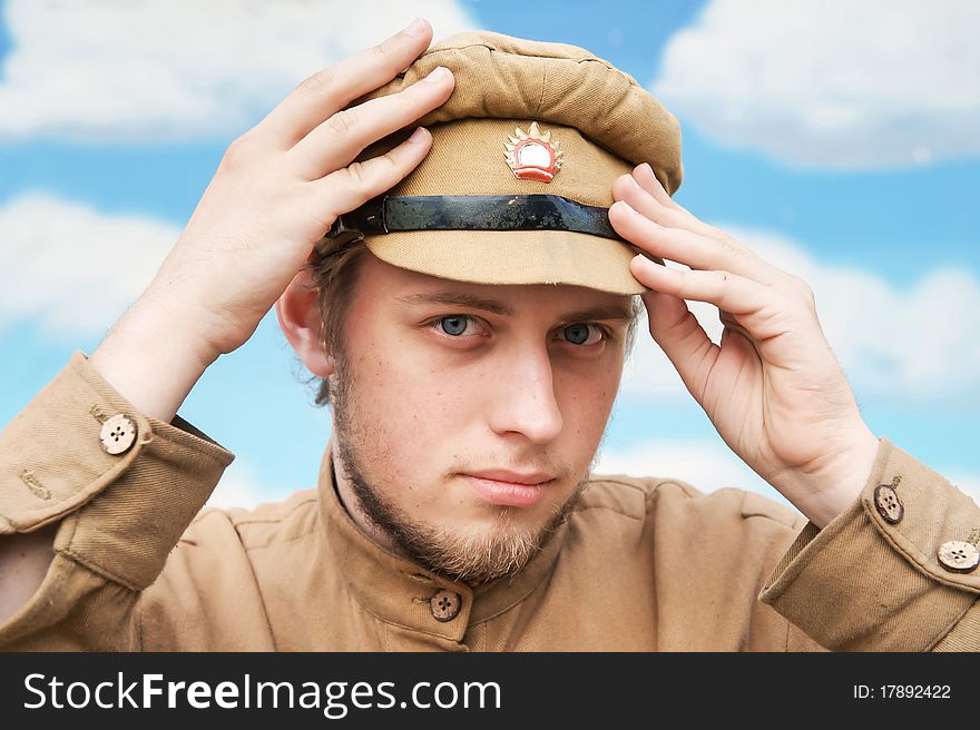 Portrait of soldier in uniform of World War 1 on the background of blue sky. Costume accord the times of World War I. Photo made at cinema city Cinevilla in Latvia. Cockade on the hat do not contain trade mark. Portrait of soldier in uniform of World War 1 on the background of blue sky. Costume accord the times of World War I. Photo made at cinema city Cinevilla in Latvia. Cockade on the hat do not contain trade mark.