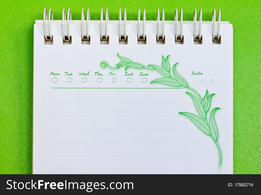Close up of a note paper on green background with clipping path