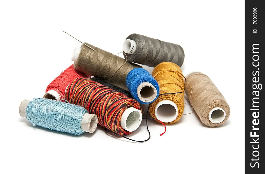 Group colored skeins of thread on white background