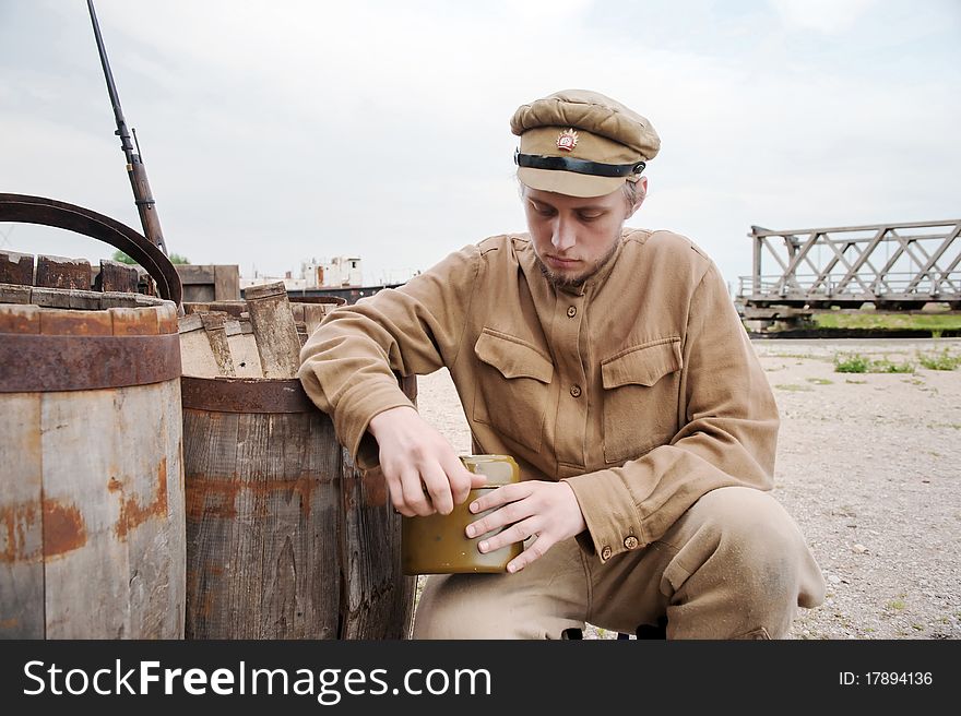 Soldier with a boiler in uniform of World War I. Costume accord the times of World War I. Photo made at cinema city Cinevilla in Latvia. Cockade on the hat do not contain trade mark. Soldier with a boiler in uniform of World War I. Costume accord the times of World War I. Photo made at cinema city Cinevilla in Latvia. Cockade on the hat do not contain trade mark.