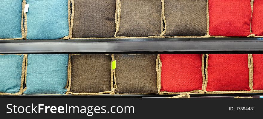 Cushions in a row on racks. Cushions in a row on racks.