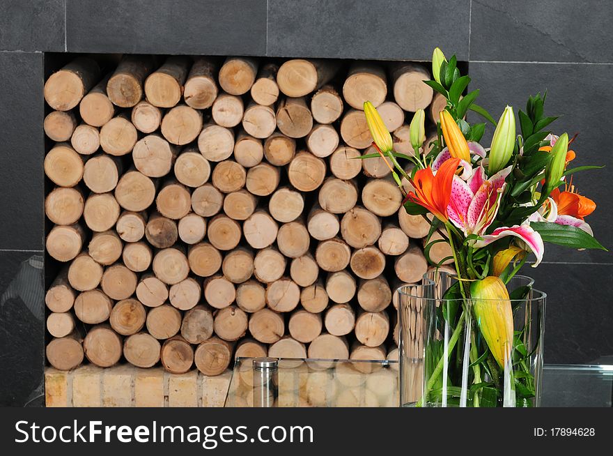 Tropical flower in a vase with stack of wood in the background. Tropical flower in a vase with stack of wood in the background