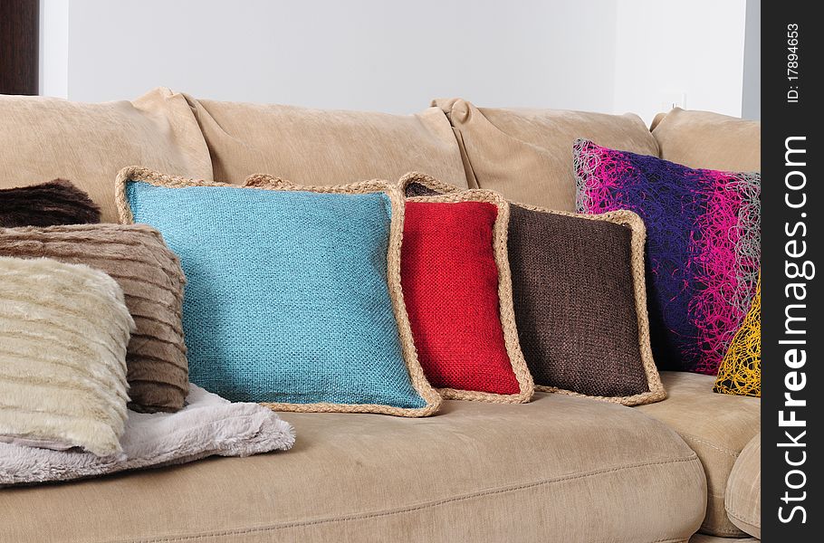 Cushions in a row on a sofa. Cushions in a row on a sofa.