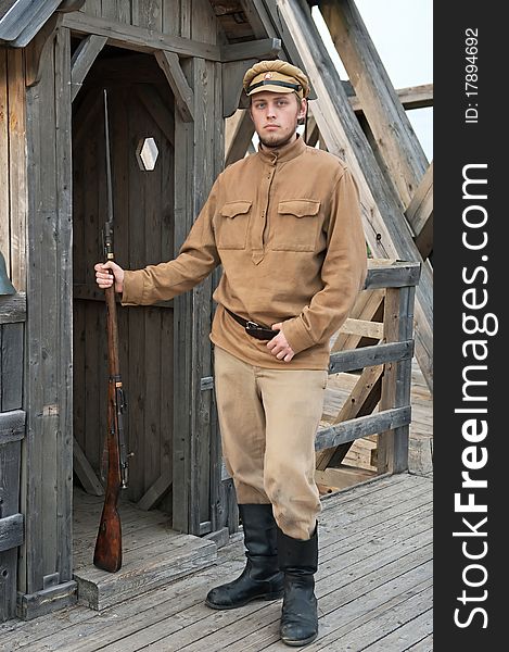 Soldier with a gun standing next to the sentry. Costume accord the times of World War I. Photo made at cinema city Cinevilla in Latvia. Soldier with a gun standing next to the sentry. Costume accord the times of World War I. Photo made at cinema city Cinevilla in Latvia.