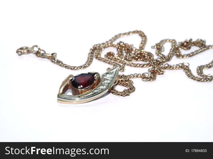 Golden chain with garnet pendent. Golden chain with garnet pendent