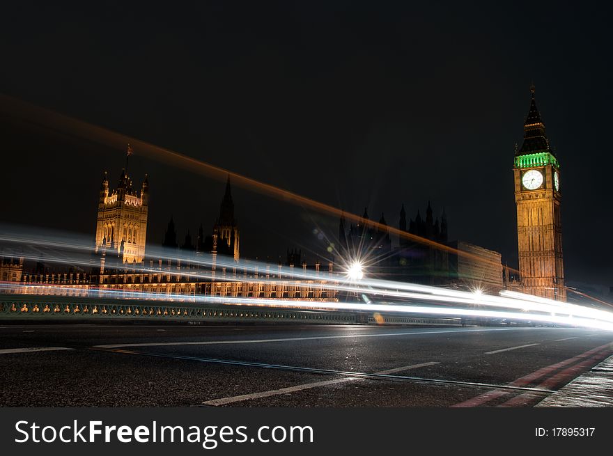 Lights of buses and cars passing the well lit buildings of the houses of parliament and big ben. Lights of buses and cars passing the well lit buildings of the houses of parliament and big ben