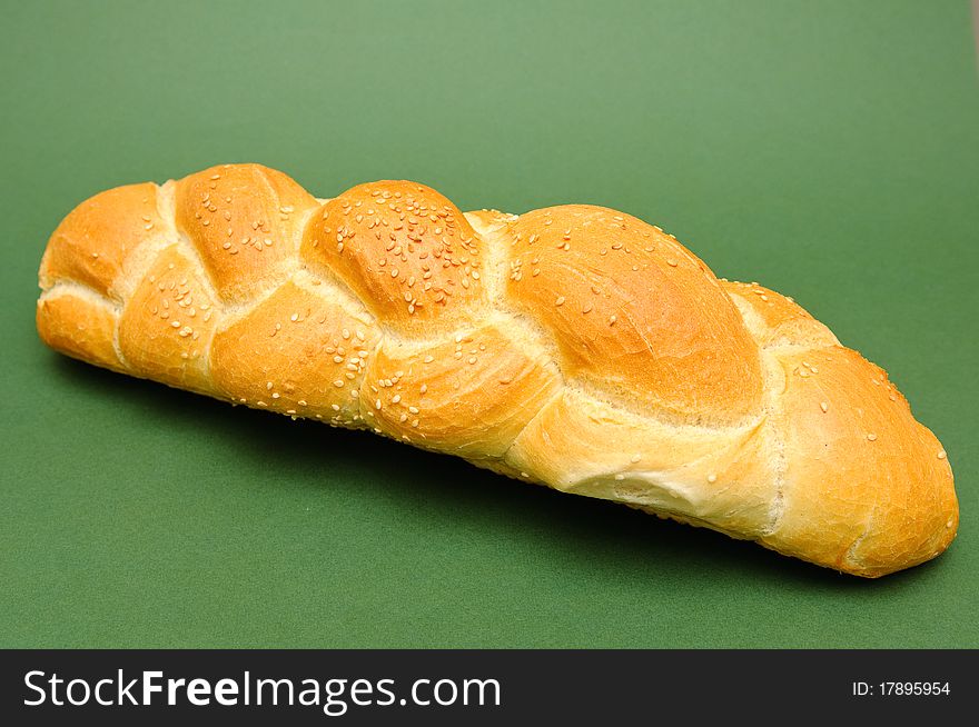 Fresh bread isolated on green background