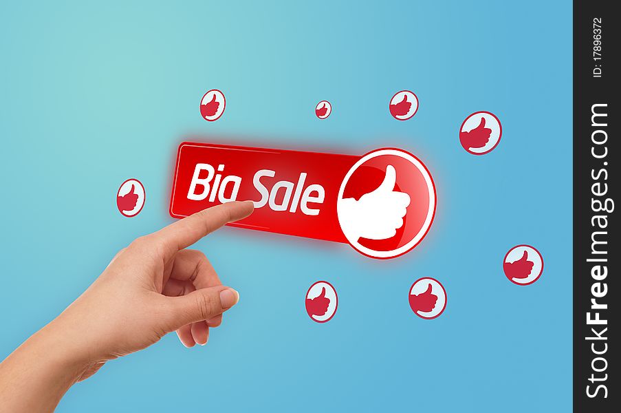 Hand pressing BIG SALE button on blue background